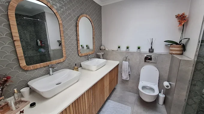 Modern bathroom tiling with double basin and feature wall finish